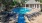 a swimming pool with chairs around it