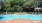 a swimming pool with chairs around it