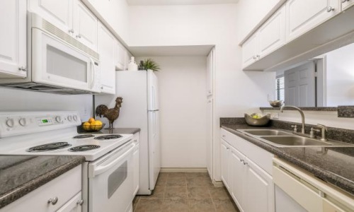 a kitchen with white cabinets