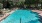 a swimming pool with trees around it