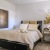 a bedroom with a bed and a lamp