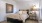 a bedroom with a bed and a lamp
