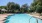 a swimming pool with trees and a blue sky