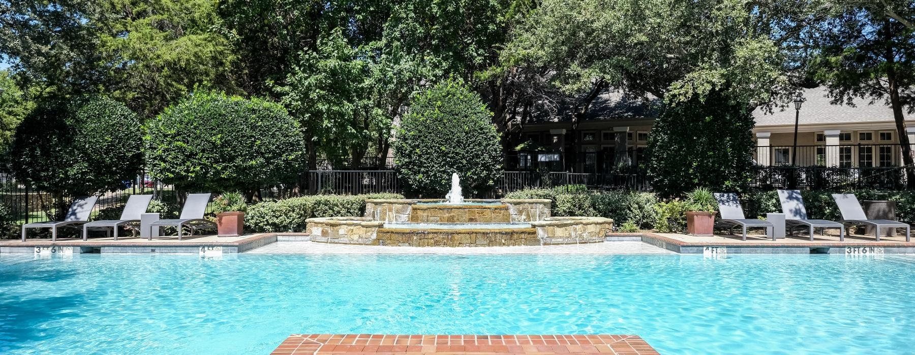 a swimming pool with chairs around it
