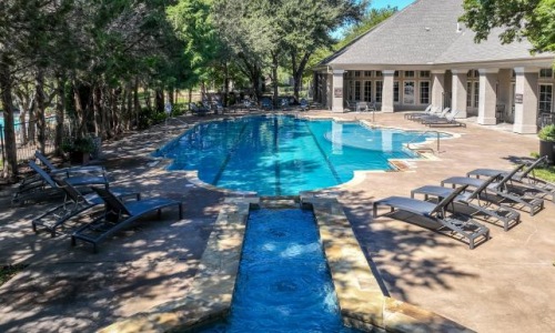 a swimming pool with chairs around it
